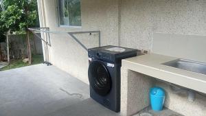 Eine Waschmaschine steht neben einem Waschbecken. in der Unterkunft Ahoyinn in Alcoy