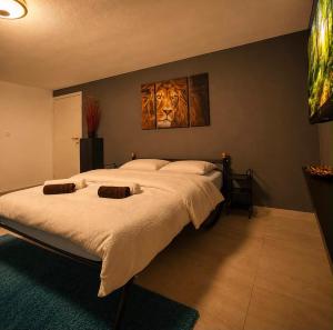 a bedroom with a bed with a painting of a lion at Villa Leah in Bihać