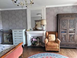 a living room with a chair and a dresser at Fleur de Lys - Free wi-fi & parking in La Haye