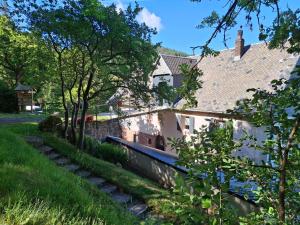 a house in the middle of a yard with trees at NORDIQUES DE LA WELCHE in Orbey