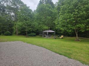 a park with a gazebo in the grass at Hyllstofta lägenhet in Klippan