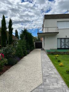 a driveway leading to a house with a garage at Vasút 10 in Balatonlelle