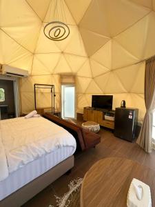 a room with a tent with a bed and a table at Glamping Grand Mazaya Private Pool in Bandung +7 photos