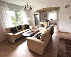 a living room with two couches and a table at Ferienwohnung Schöne Aussicht in Nieheim +18 photos