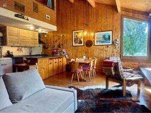 a kitchen and living room with a couch and a table at Chalet Costa Rotian in Commezzadura +19 photos