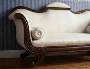 a white couch sitting in a room at Pałac Przybyszewo in Przybyszewo +15 photos
