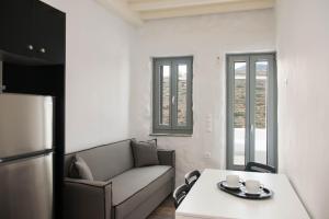 a living room with a couch and a table at Athina Exquisite Houses in Kastron