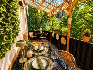 a patio with a table and chairs and a pergola at 'GoldPath' OldTown - Apartments Passau in Passau