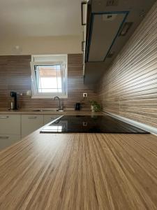 a kitchen with a wooden floor and a sink at Sky Apartment in Ofrínion +6 photos