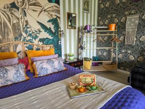 a bedroom with a bed with a tray of food on it at La Fraizière in Arnaville