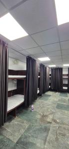 a room with bunk beds and curtains in a room at Chandra Dormitory in Varanasi
