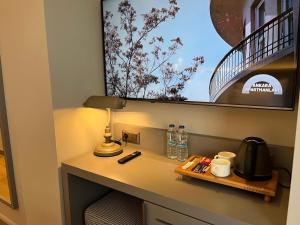 a room with a desk with a lamp and a sink at Göcek Lykia Resort Premium Concept Hotel in Göcek