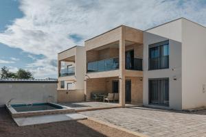 a house with a swimming pool in front of it at Villa Anida in Ulcinj