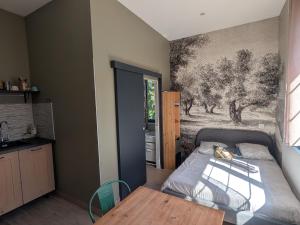 a bedroom with a bed and a painting on the wall at Moustier in Montauban