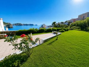 a park with a view of the water and a lawn at Maridea - Villa Alta Marea in Ponza