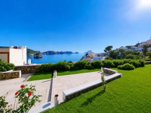 a park with a bench and a view of the water at Maridea - Villa Alta Marea in Ponza