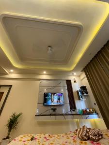 a room with a tv on the ceiling at Tehzeeb living in Lucknow