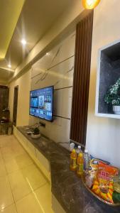 a room with a television and a counter with food on it at Tehzeeb living in Lucknow