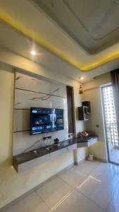 a living room with a tv on a wall at Tehzeeb living in Lucknow