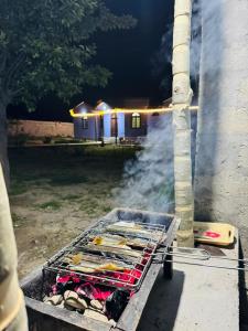a grill with a bunch of food on it at Valley View Homestay in Bīrgal