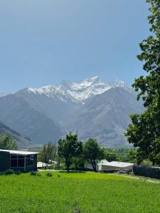a mountain in the distance with a house and trees at Valley View Homestay in Bīrgal