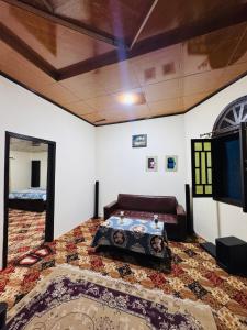 a bedroom with a bed and a tv in a room at Valley View Homestay in Bīrgal