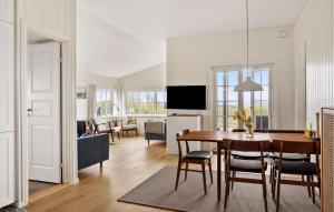 a dining room and living room with a table and chairs at 3 Bedroom Cozy Home In Haderslev in Haderslev