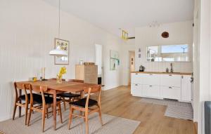 a kitchen and dining room with a wooden table and chairs at 3 Bedroom Cozy Home In Haderslev in Haderslev