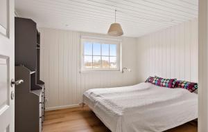 a white bedroom with a bed and a window at 3 Bedroom Cozy Home In Haderslev in Haderslev +15 photos