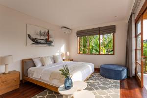 a bedroom with a large bed and a window at Villa Pura Bali in Canggu +80 photos