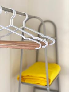 a metal shelf with a yellow cushion on it at Blue Loft 360 in Patra