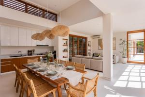 a kitchen and dining room with a table and chairs at Villa Pura Bali in Canggu