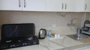 a kitchen counter with a television and a sink at Sidi Kankouch Bay in Tangier