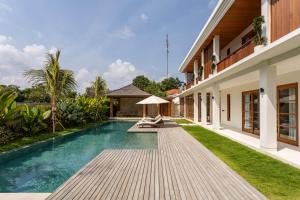a swimming pool in the backyard of a villa at Villa Pura Bali in Canggu