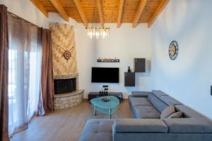 a living room with a couch and a tv at George's Paradise in Afantou