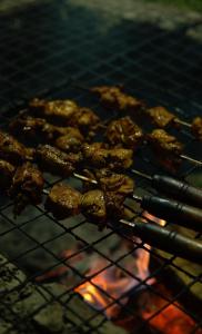 a bunch of food cooking on a grill at Art Mile Kalimpong in Kalimpong