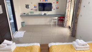 a room with two beds and a television and a table at Round toot in Jinning
