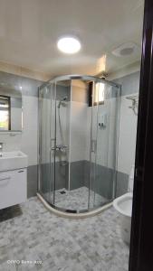 a bathroom with a shower and a toilet and a sink at Round toot in Jinning