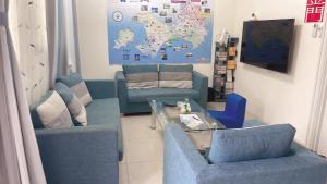 a living room with two blue chairs and a table at Round toot in Jinning