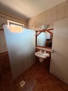 a bathroom with a toilet and a sink at Adél Apartman in Sárvár +20 photos