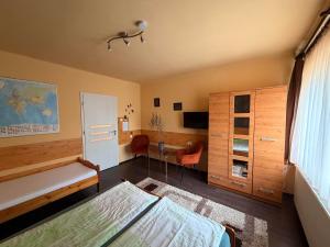 a bedroom with a bed and a desk in it at Adél Apartman in Sárvár