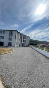 a large white building with a fence in front of it at SunVillaTuzi in Tuzi