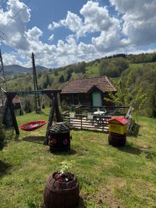 a group of tires sitting in the grass in front of a house at Turizam Raković in Ivanjica +8 photos