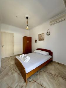 a bedroom with a large bed with towels on it at Coral Blue By Infinity in Nea Kallikrateia
