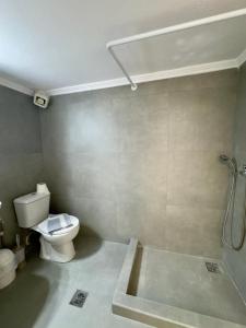 a bathroom with a toilet and a shower at Coral Blue By Infinity in Nea Kallikrateia