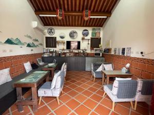 a restaurant with tables and chairs and a counter at Naya"s Homestay in Jincheng