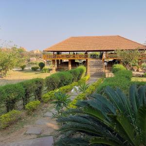 a building with a walkway in front of it at LEO DREAM HAMPi in New Hampi