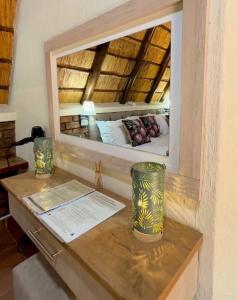a mirror reflecting a bed in a room at Selukwe Safari Lodge in Marloth Park