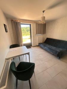 a living room with a couch and a table and chairs at B&B Angueur in Montrem