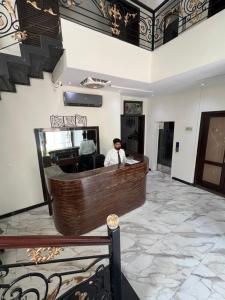 a man sitting at a bar in a salon at brick hotel & luxury suites in Lahore +17 photos